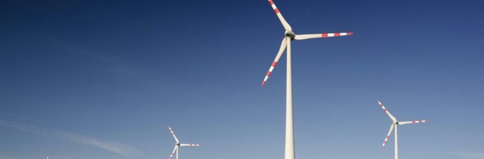 windmills on grass field at daytime