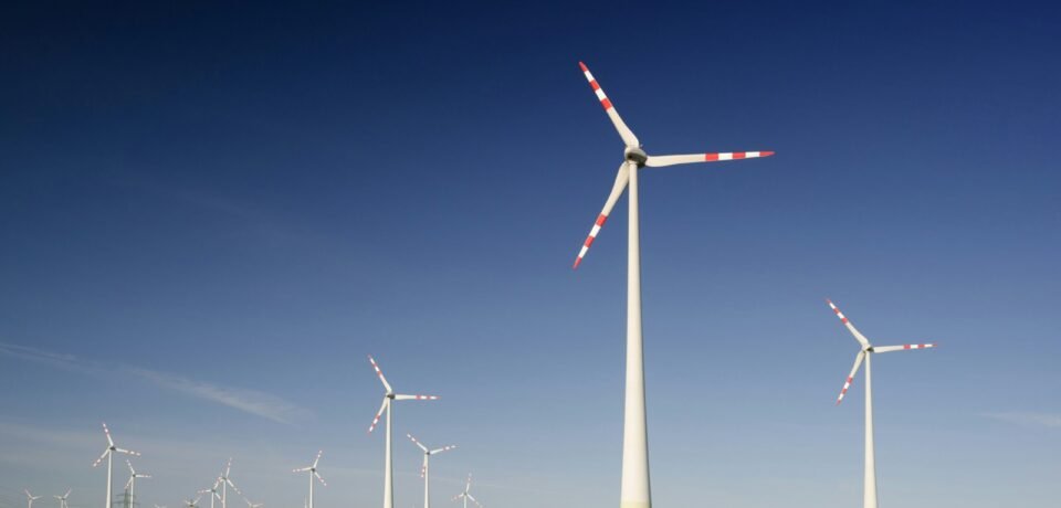 windmills on grass field at daytime